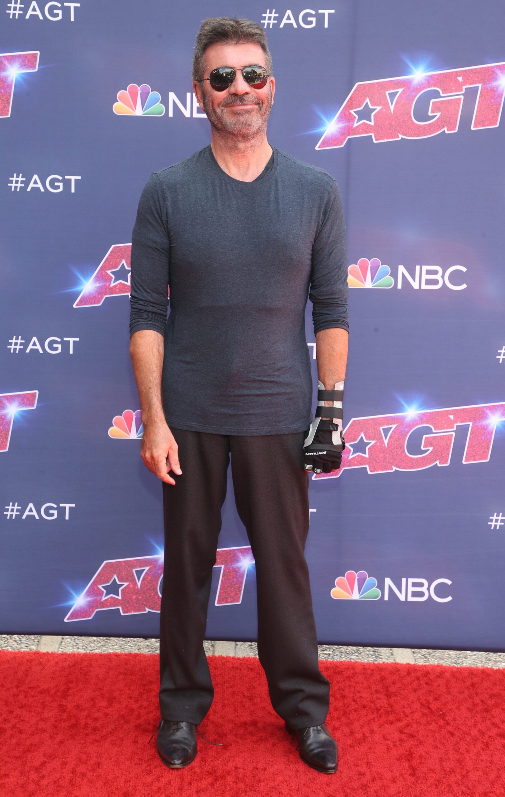 Simon Cowell smiling with sunglasses on at AGT