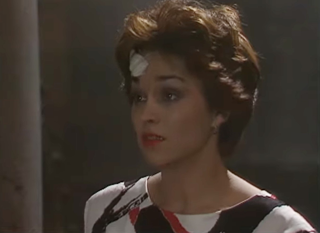 Janet Fielding as Tegan in Doctor Who, she has a cut on her head and a sad expression