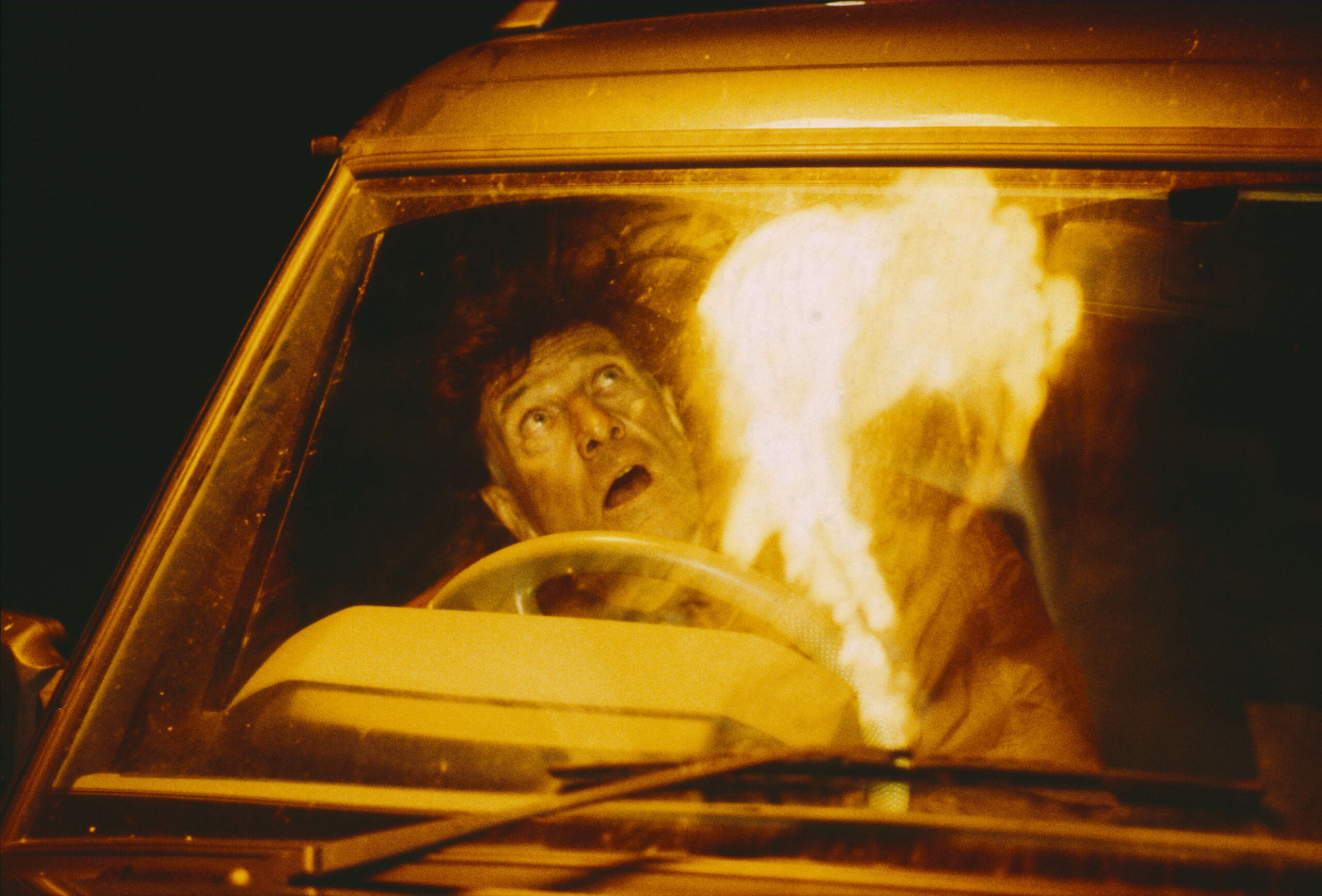 Frank looks up into the sky as burning wreckage descends