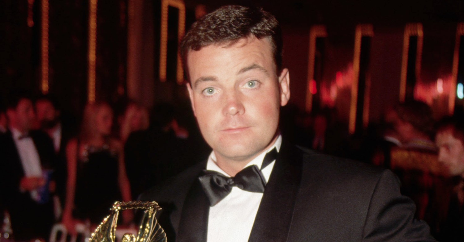 John Wayne Bobbett in dinner suit accepting an award