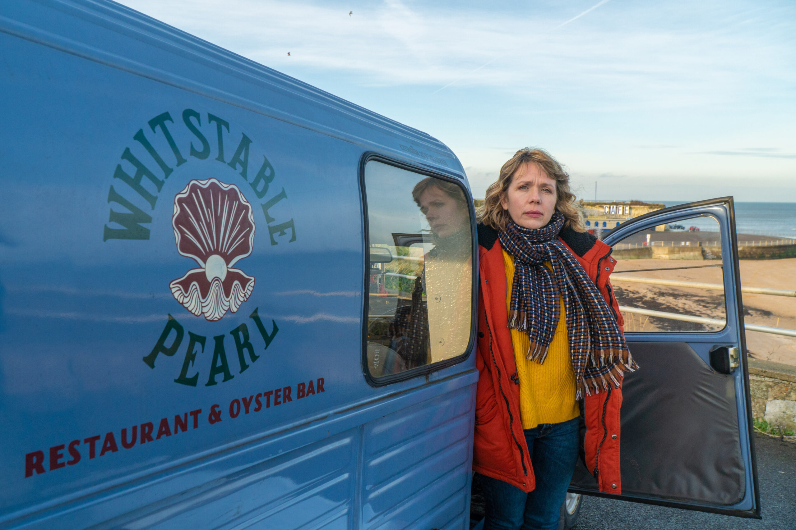 Kerry Godliman as Pearl Nolan in Whitstable Pearl - she looks out of a blue van with a concerned expression