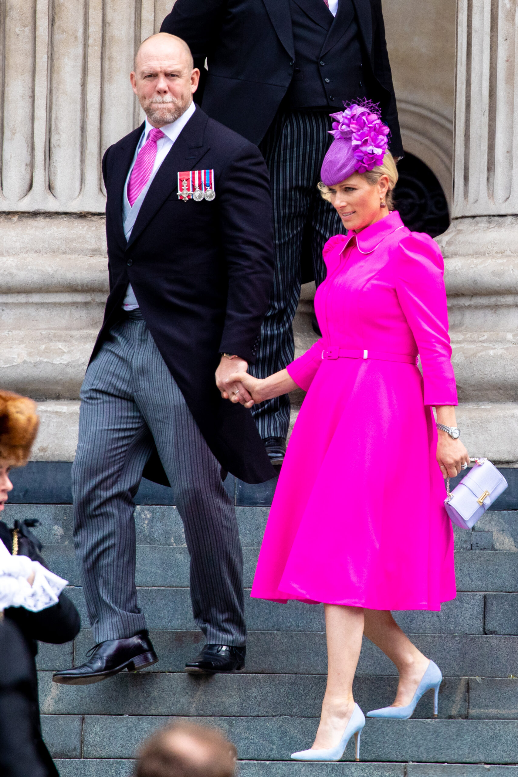 Mike Tindall in a suit and Zara in a bright pink dress