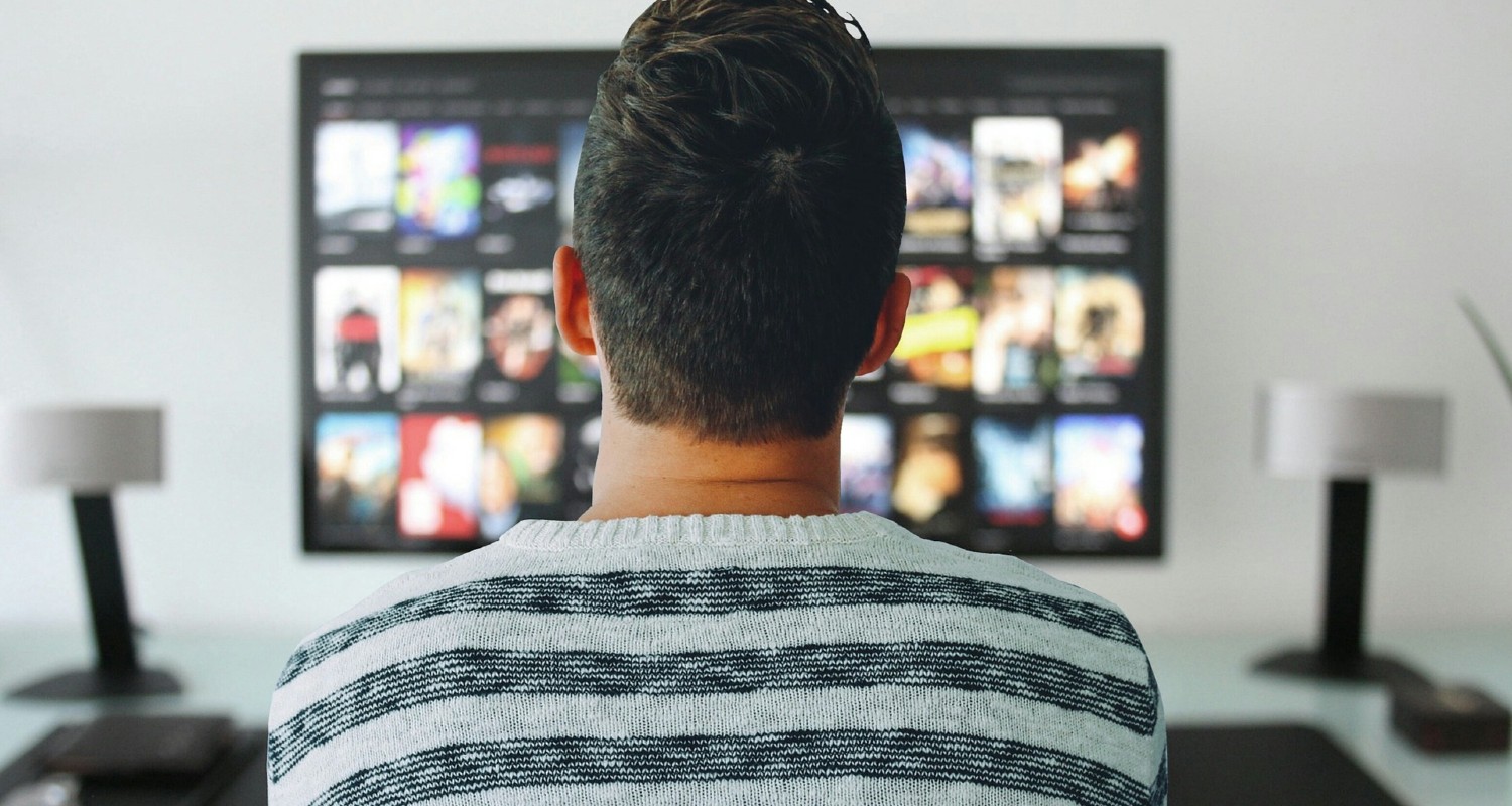 Man in front of movies on TV