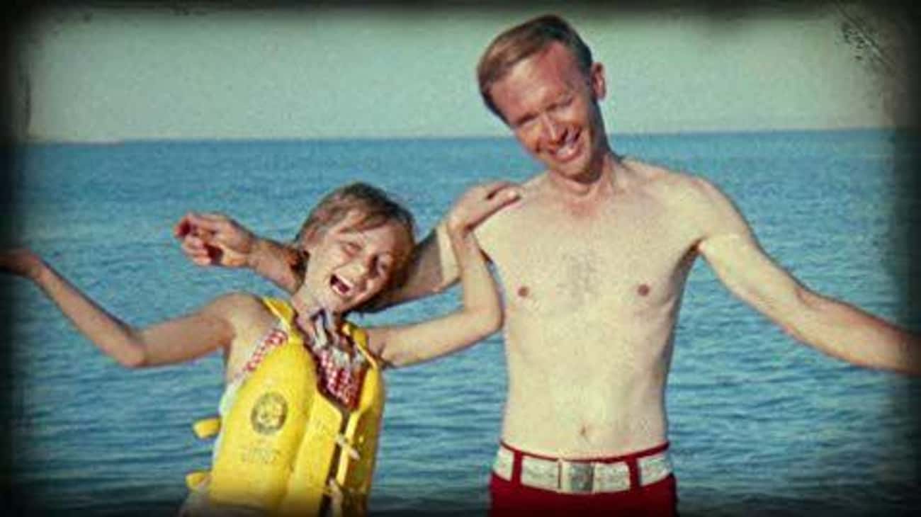 Image of Jan Broberg and Robert Berchtold, they smile and hold each other at the beach