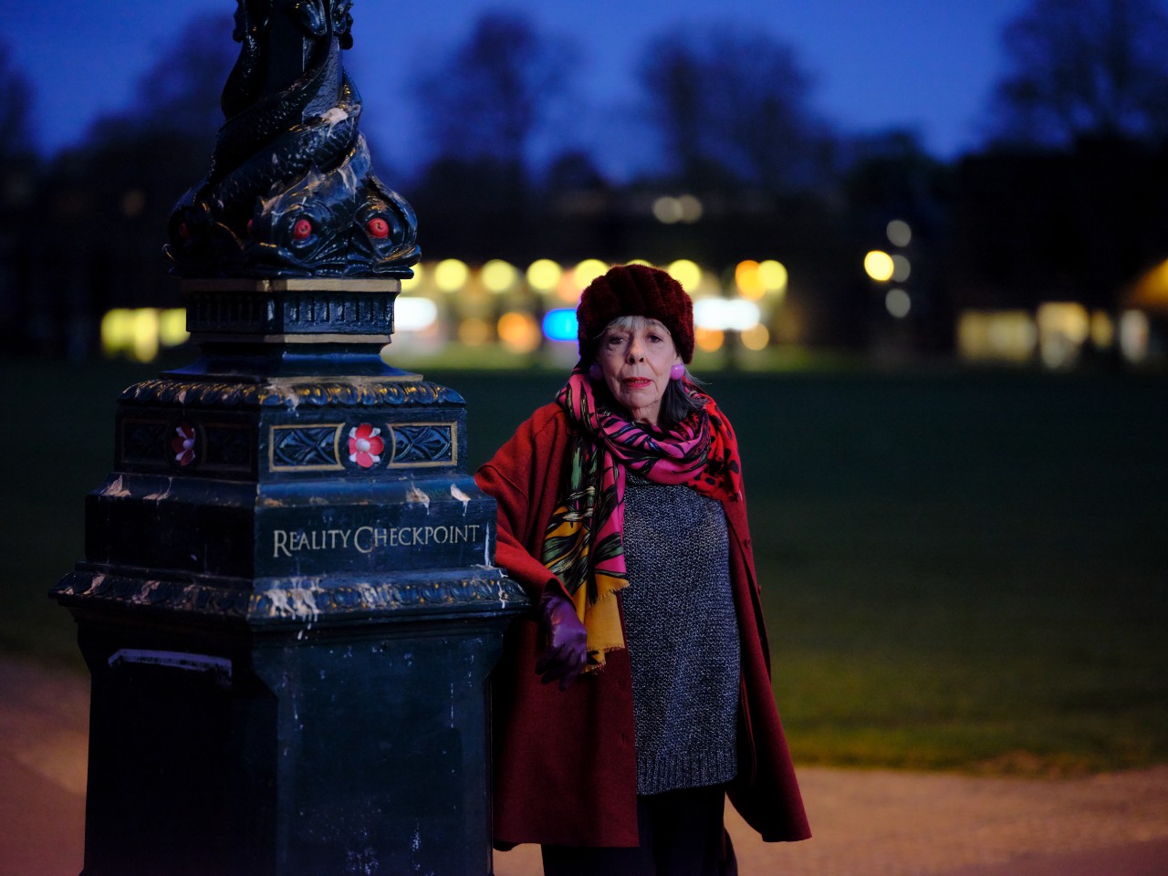 Frances de la Tour as Adelaide in Professor T, she stands in a park at night with a concerned expression