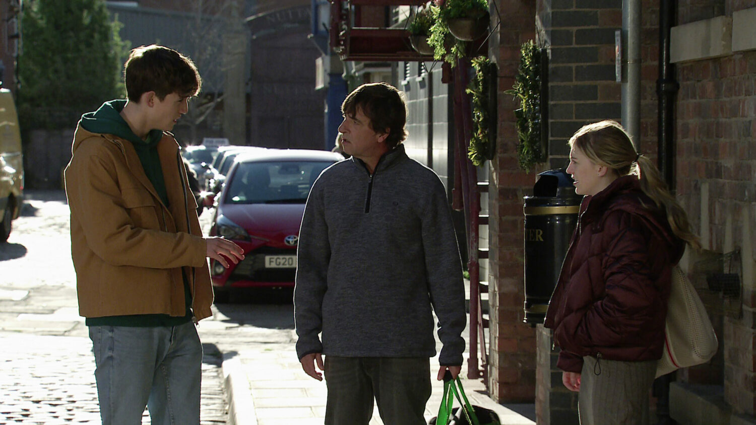 Eric talks to Summer and Aaron in the street on Coronation Street