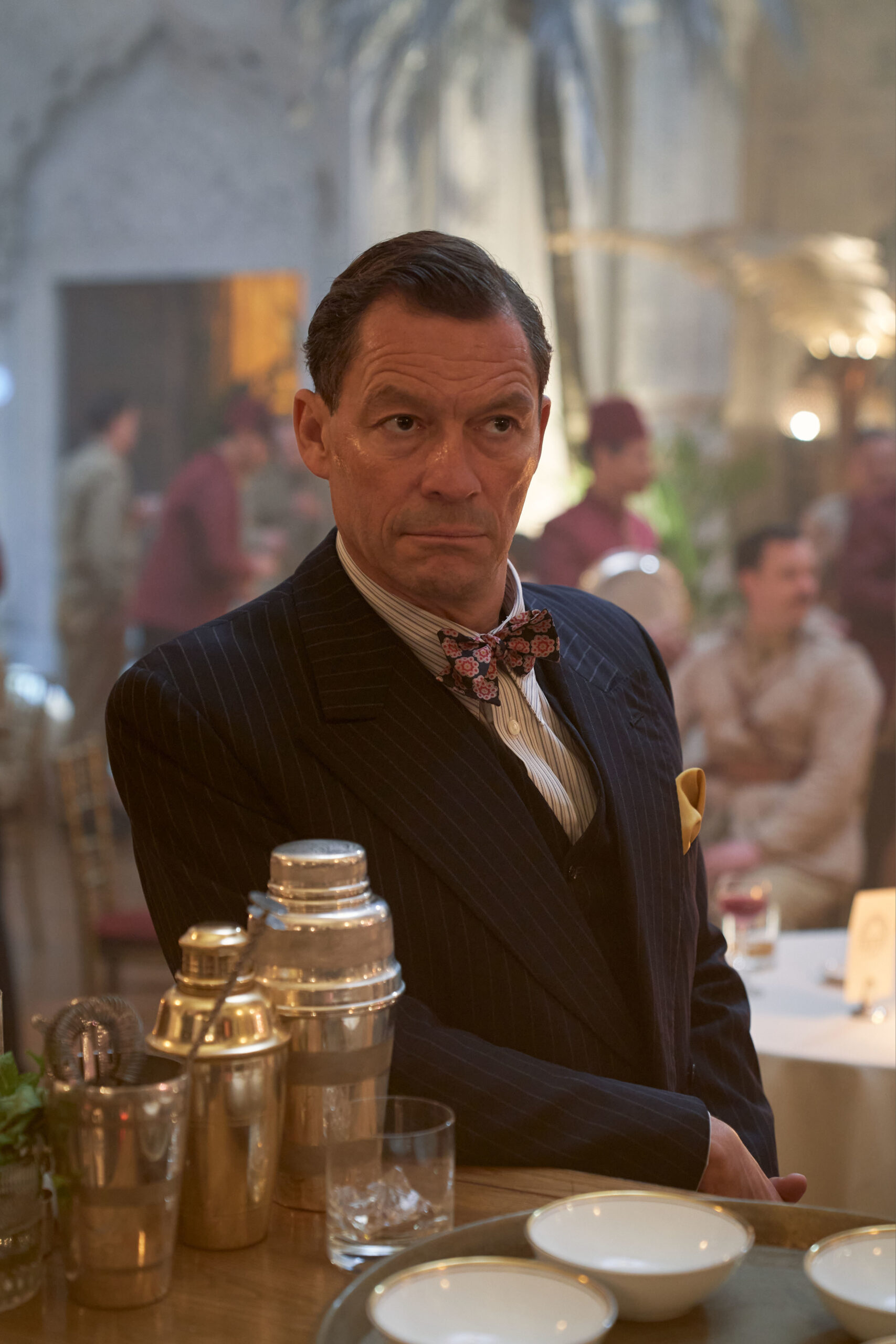 Dominic West posing at a table in SAS Rogue Heroes