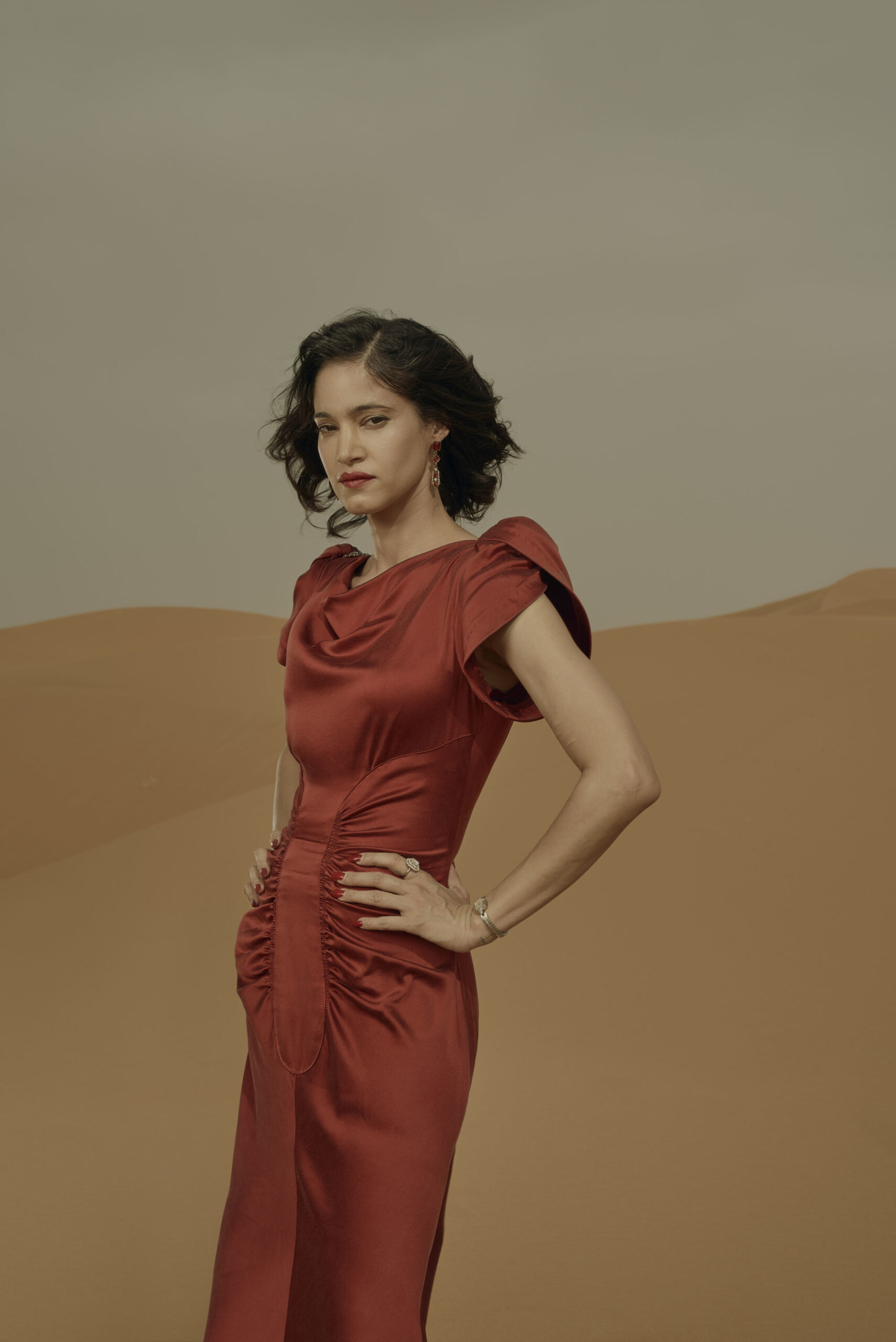 Sofia Boutella wearing a red dress in SAS Rogue Heroes 