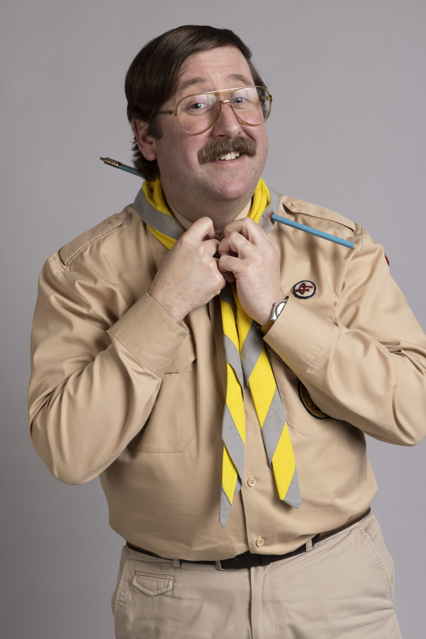 Pat fixes his tie and smiles in Ghosts