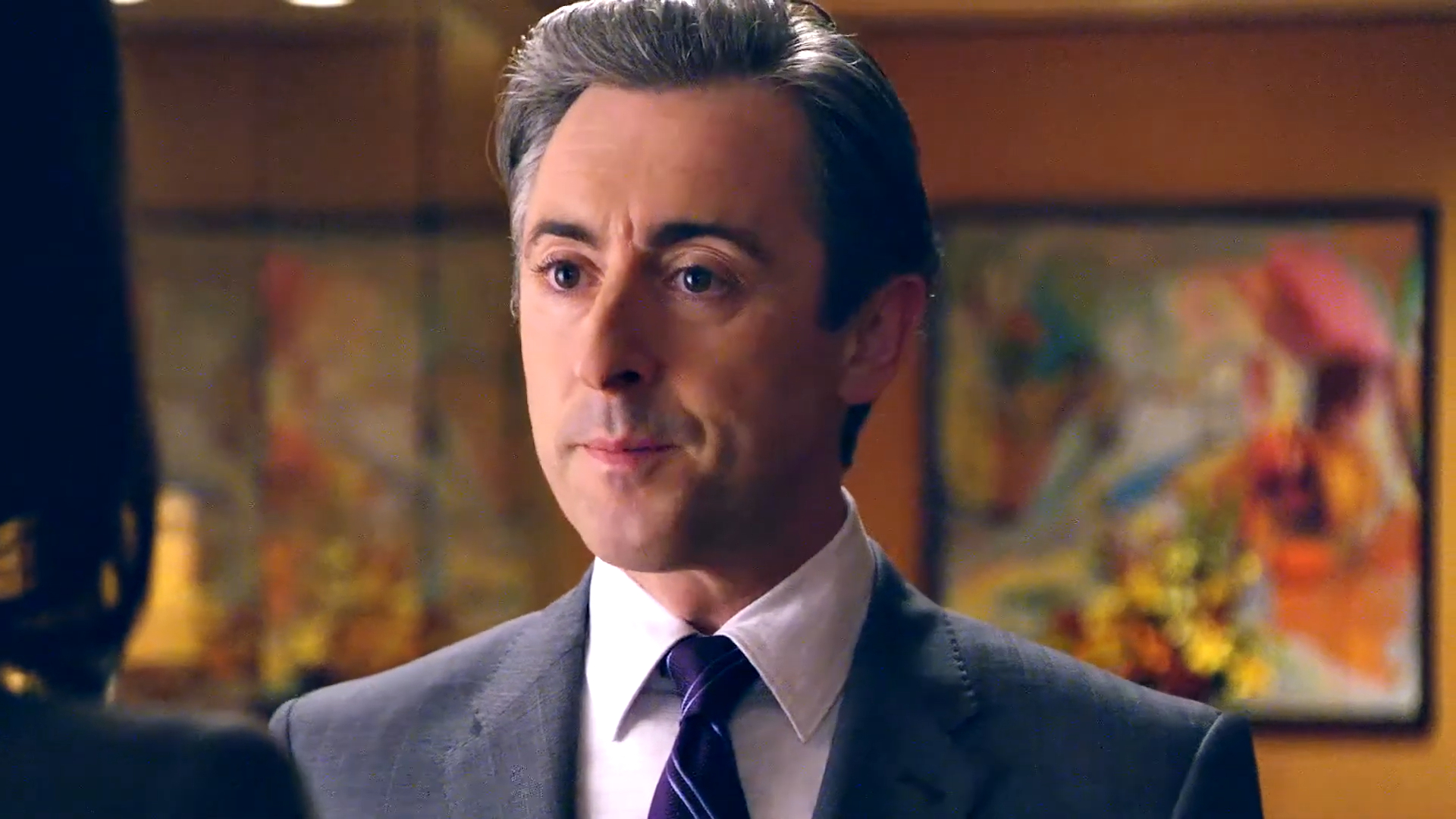 Eli Gold smiles at a woman in The Good Wife