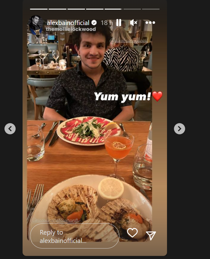 Alex Bain (Corrie) sitting in front of a plate of food in an Instagram story