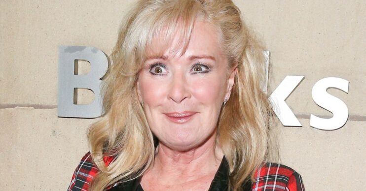 Beverley Callard smiling wearing red