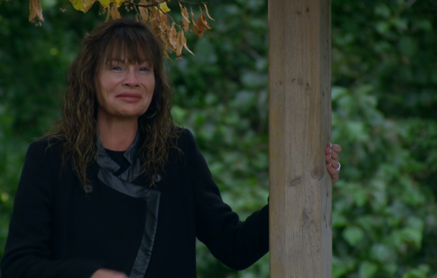 Emmerdale's Chas holding onto a post outside, sobbing