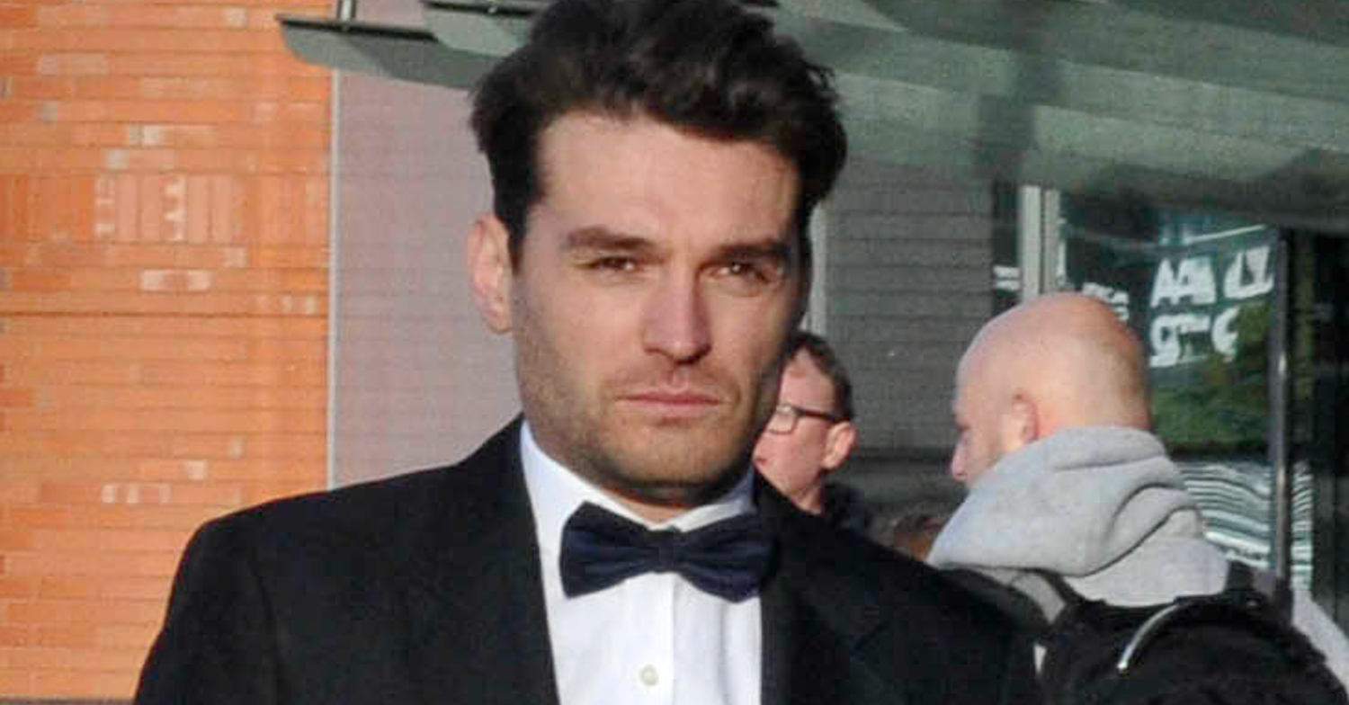 Emmerdale's Lawrence J Robb outside, looking serious in a bow tie and suit