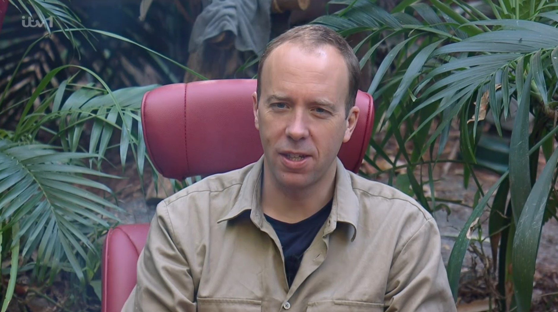 Matt Hancock sits in the red leaders chair on I'm A Celebrity