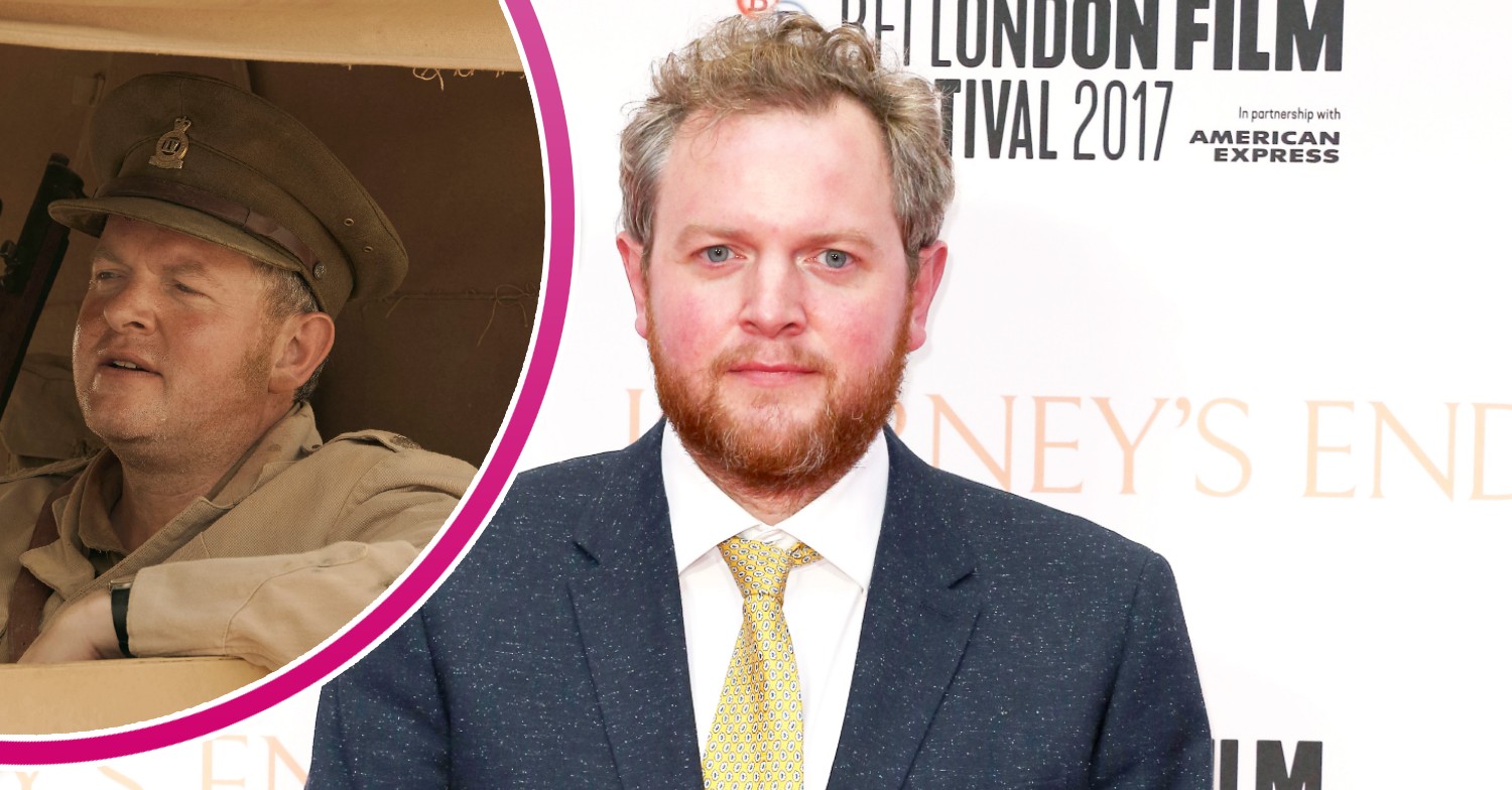 Miles Jupp smiling on the red carpet and wearing army uniform in SAS Rogue Heroes
