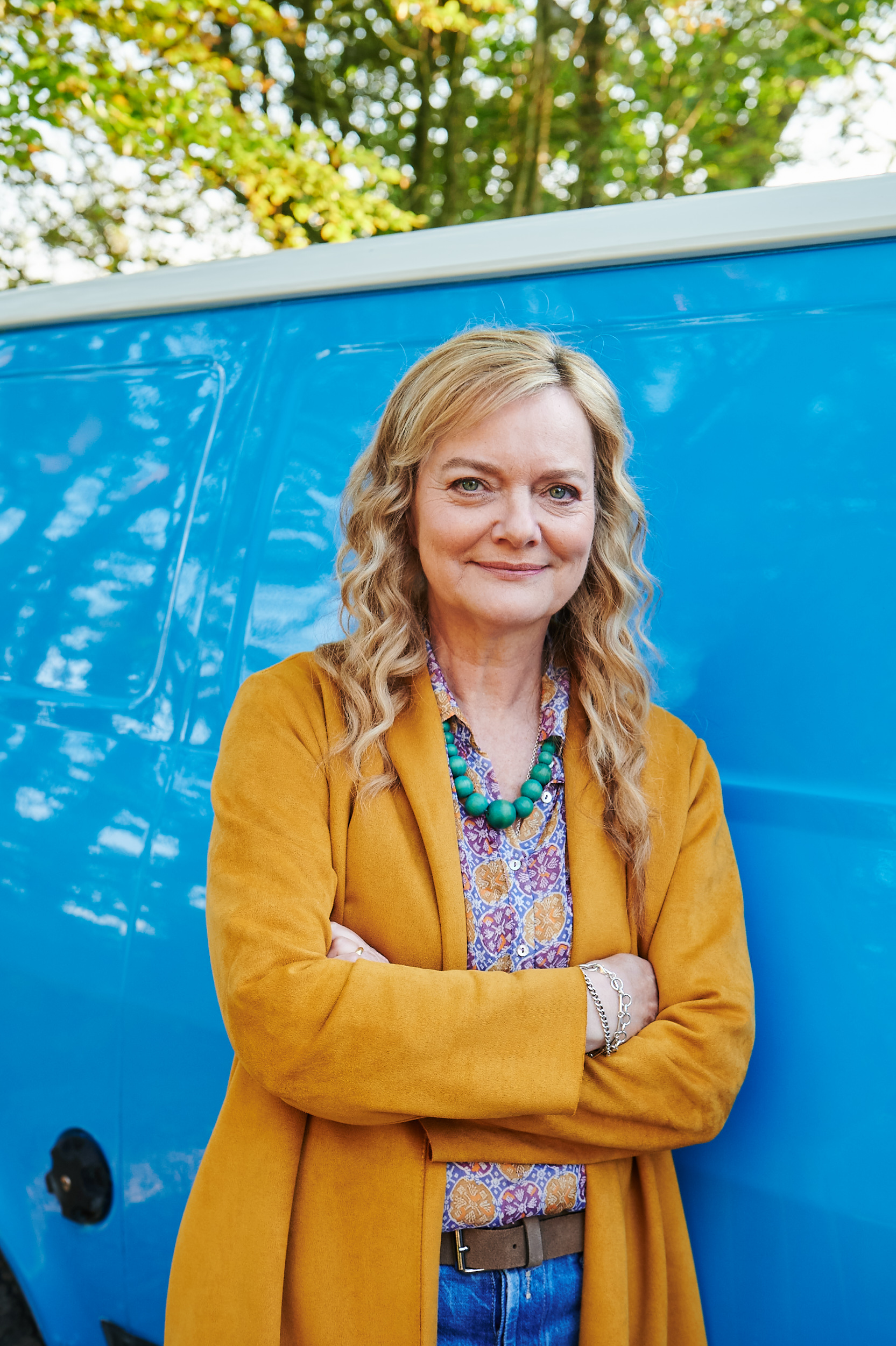 Beth Stone stands next to her van in Queens of Mystery
