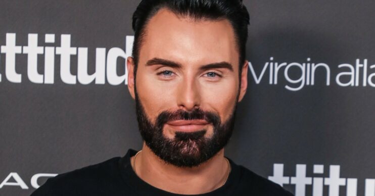 Rylan Clark wearing black and smiling