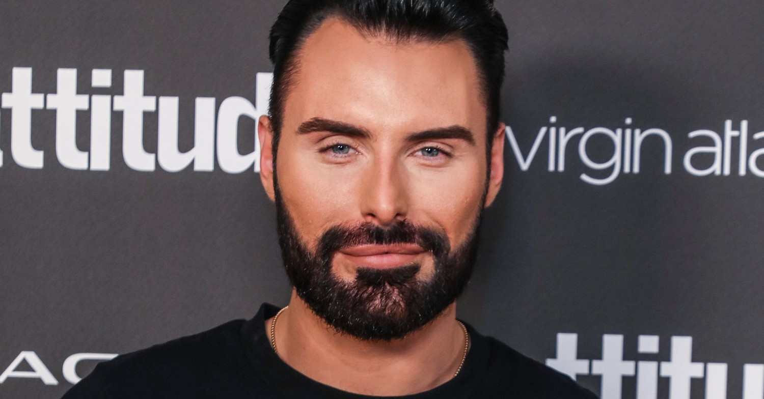 Rylan Clark wearing black and smiling