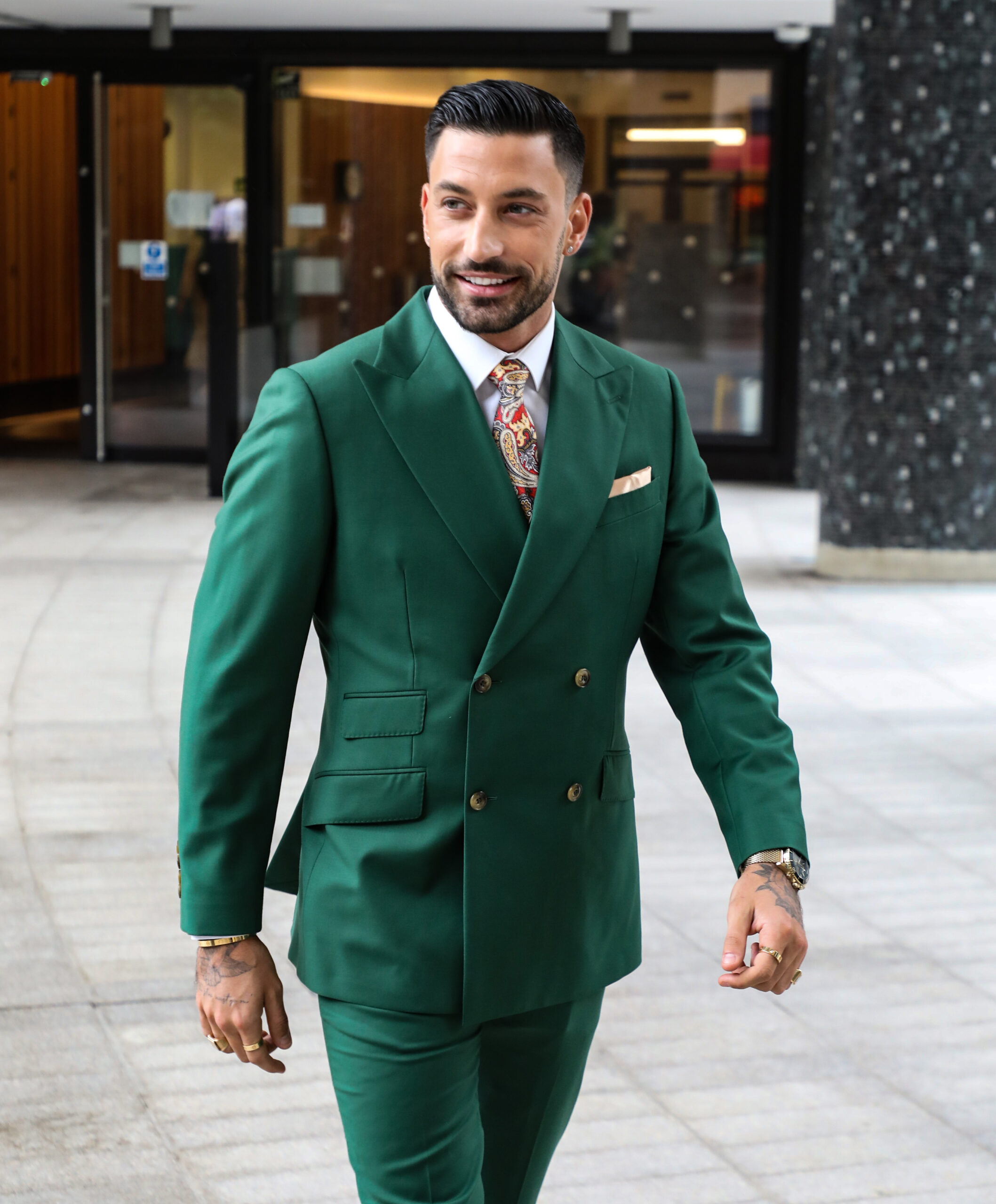 Strictly star Giovanni Pernice smiling in a green suit
