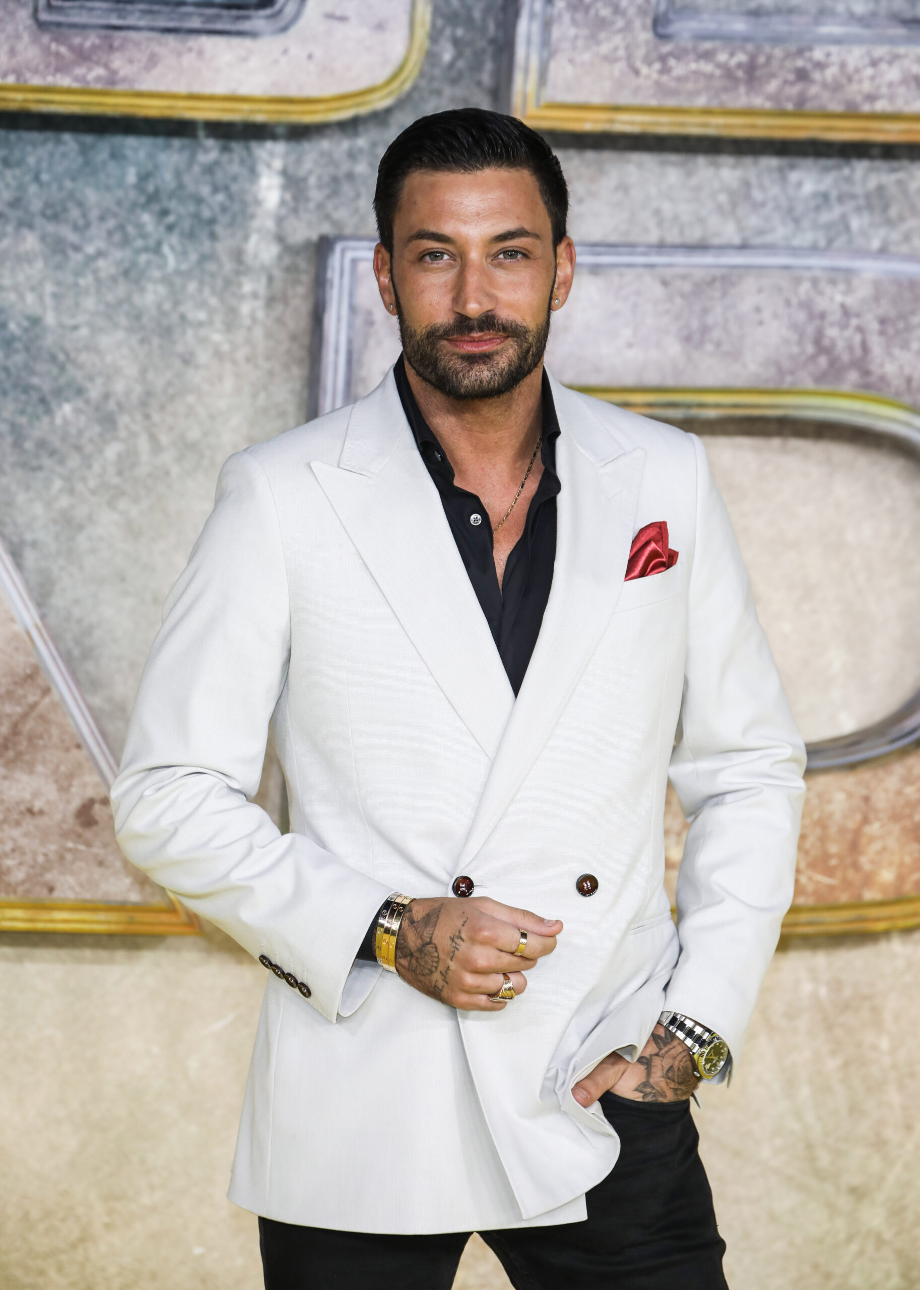 Giovanni Pernice in a white jacket at a film premiere