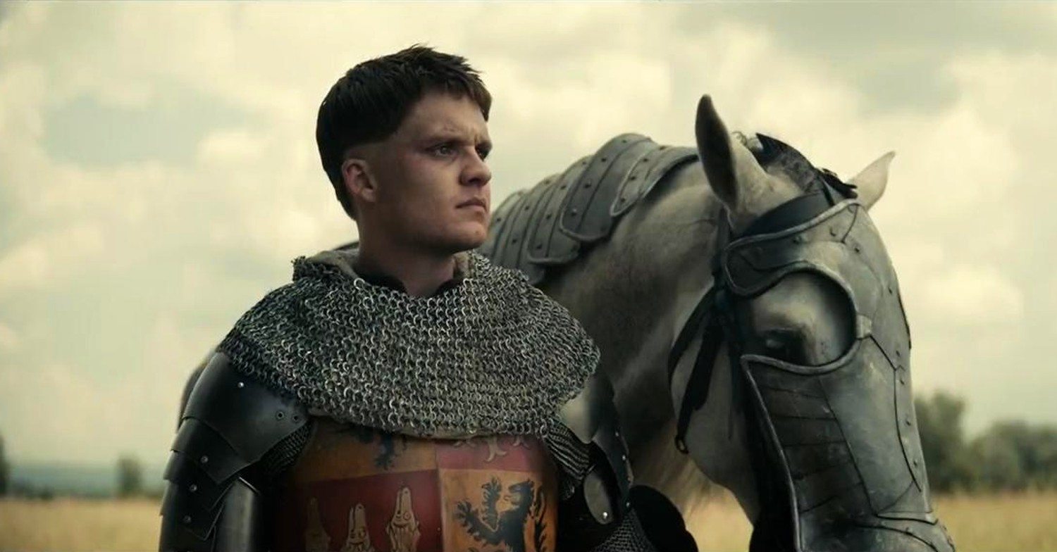 Tom Glynn-Carney standing with a horse in The King