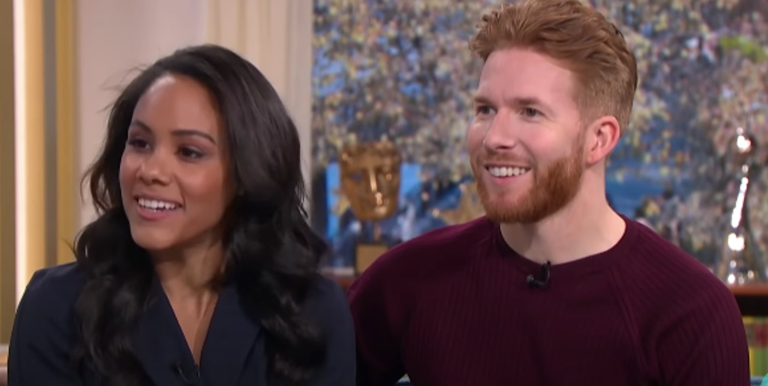 Alex Scott and Neil Jones smiling during interview