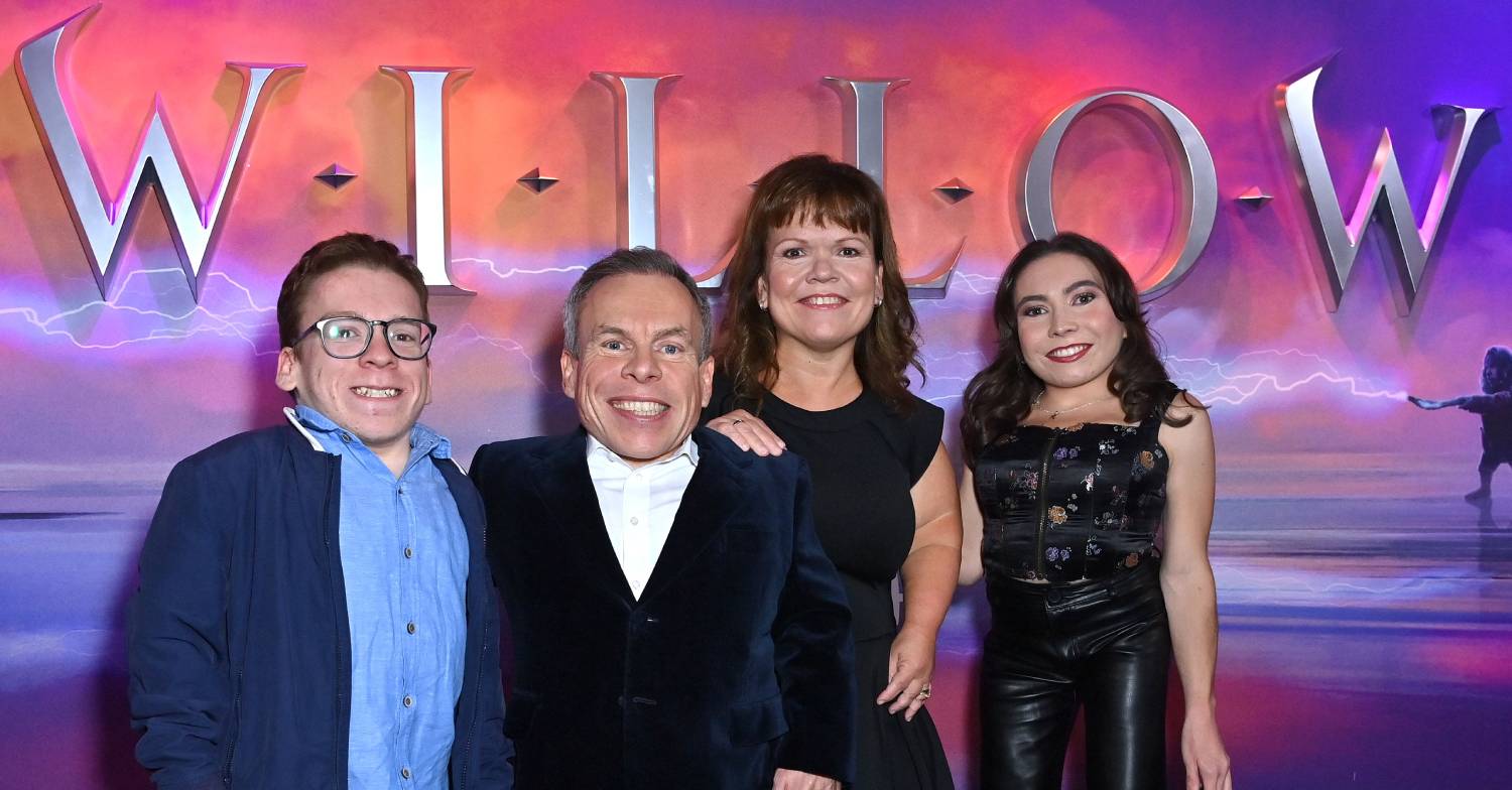 Warwick Davis smiles alongside his family at Willow showing
