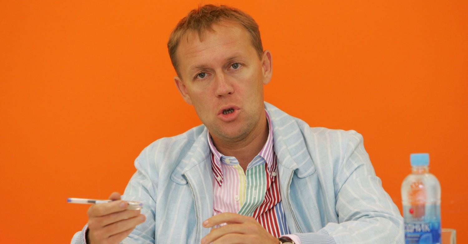 Andrey Lugovoy - a suspect in Litvinenko poisoning case - speaking in front of an orange backdrop