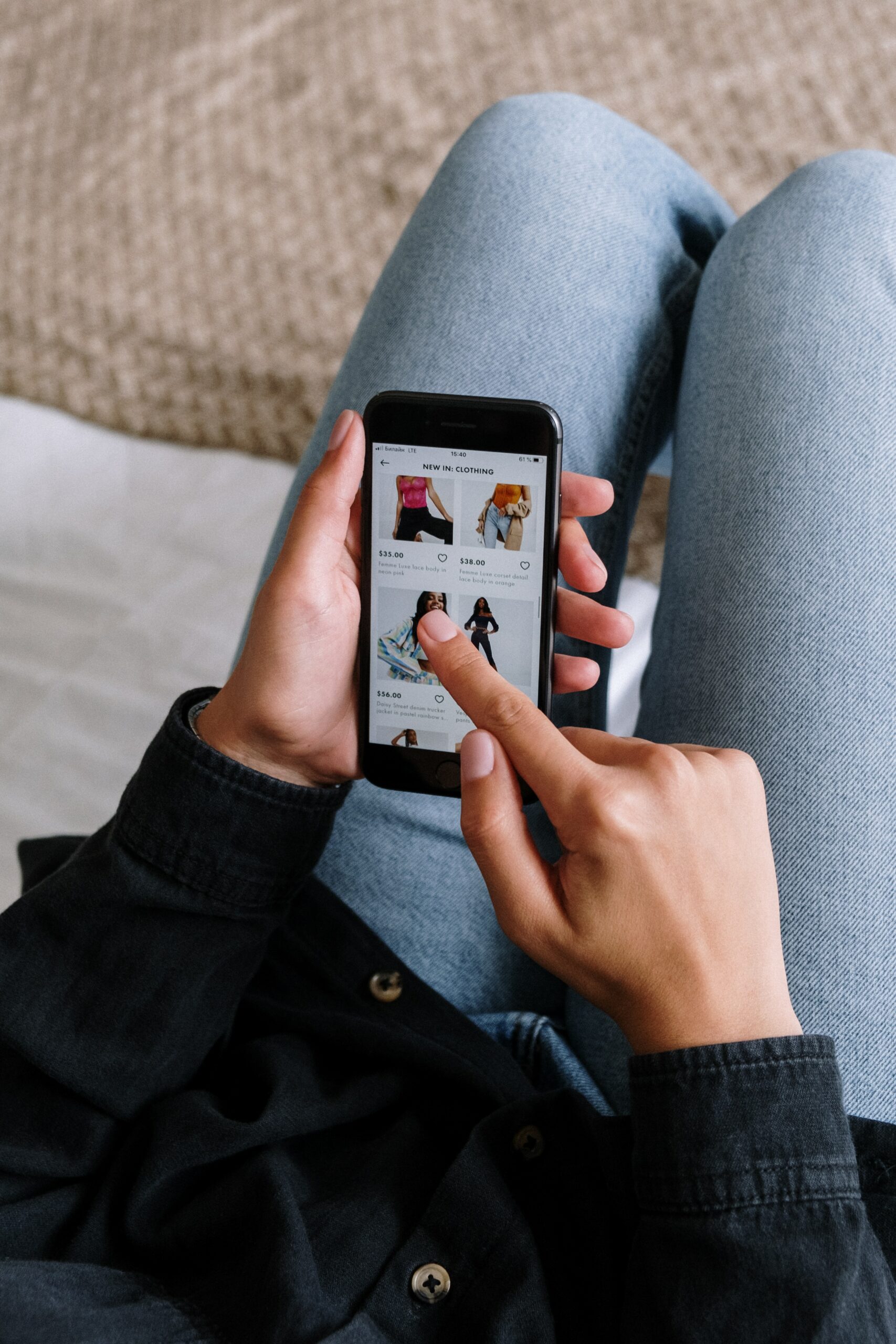 Person scrolling and shopping on their phone