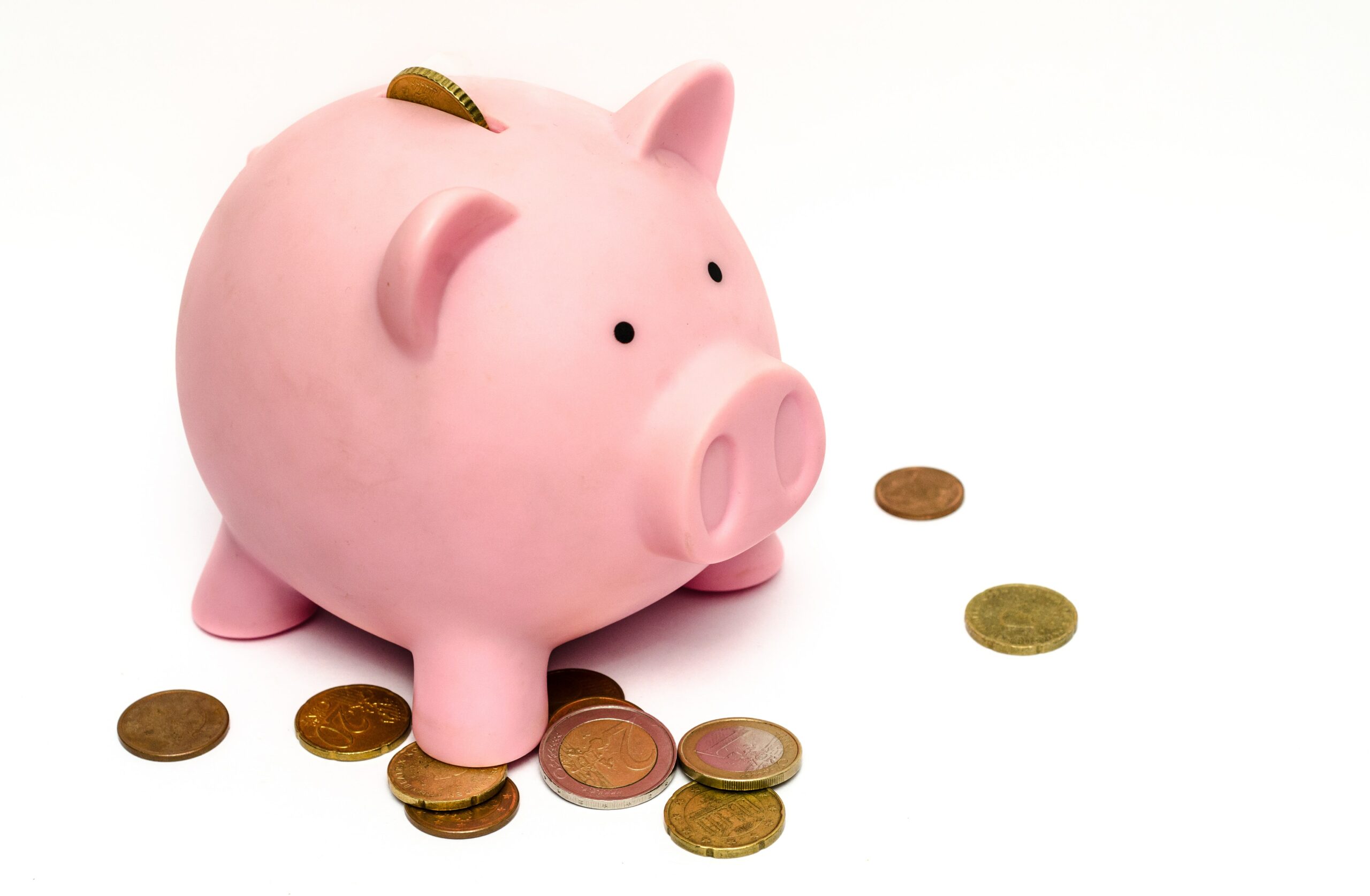 A pink piggy band with coins around it