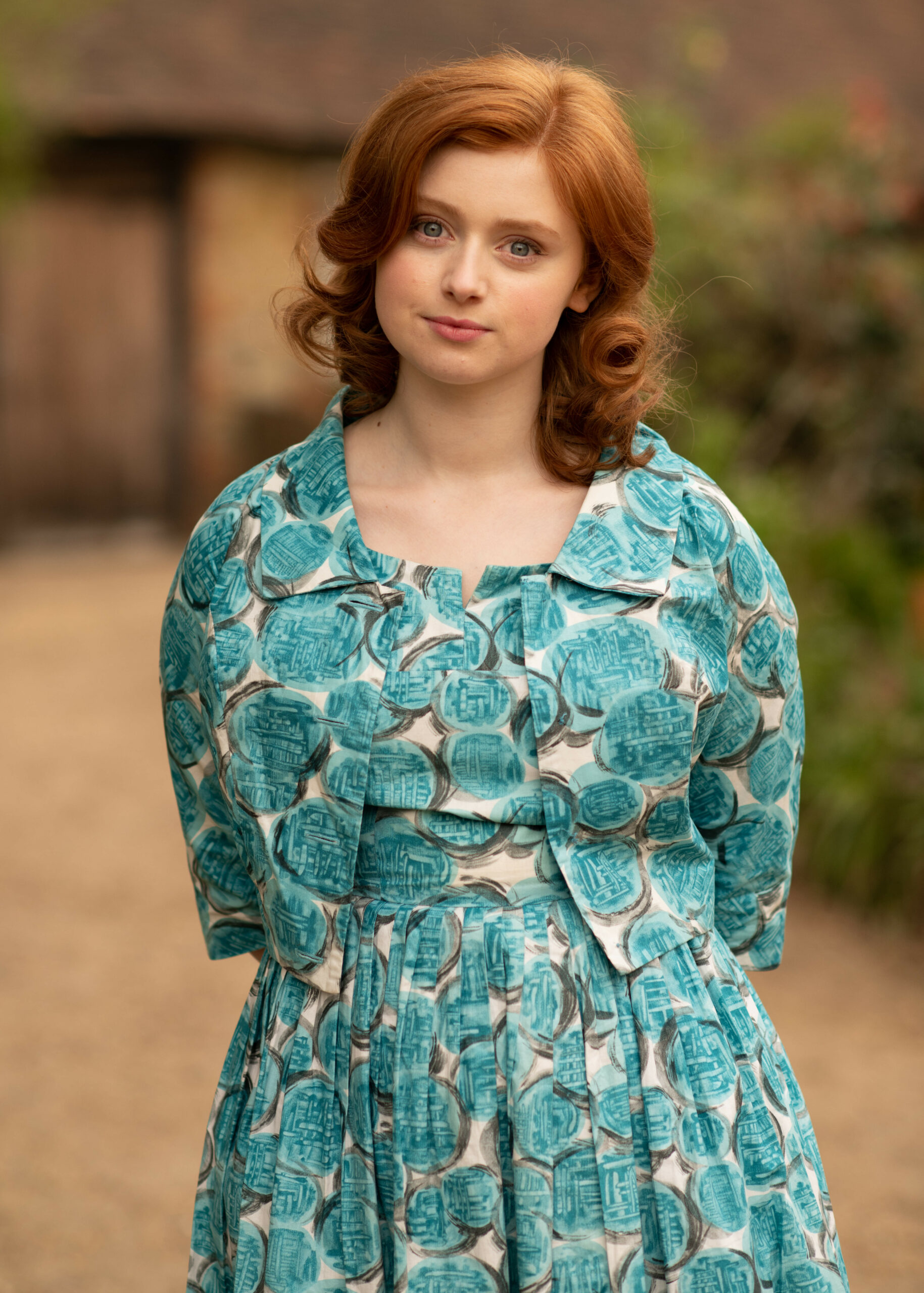 Lydia Page wearing a blue dress in The Larkins