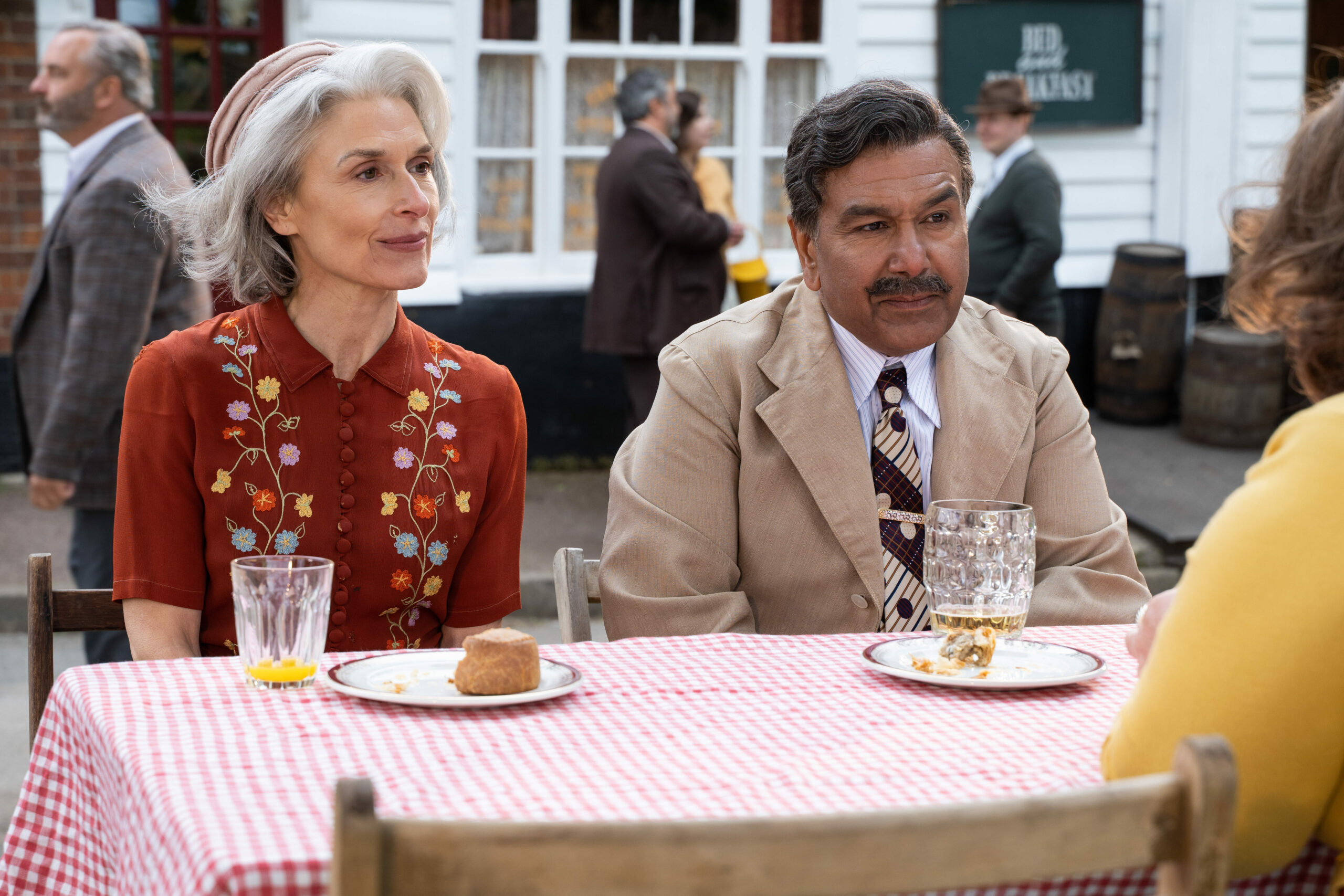 Amelia Bullmore sitting next to Kriss Dosanjh in The Larkins