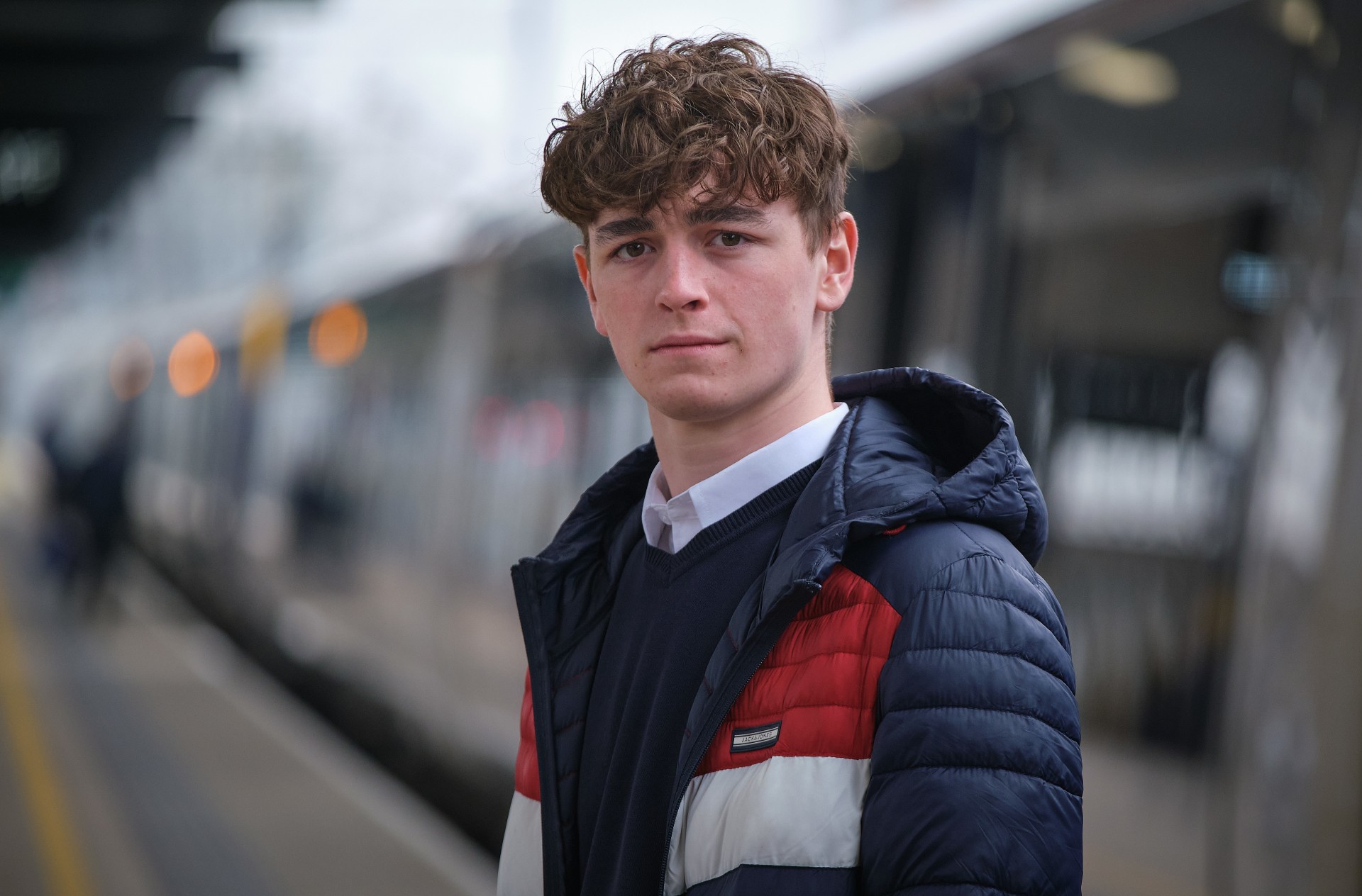 Rhys Connah posing next to a train in Happy Valley