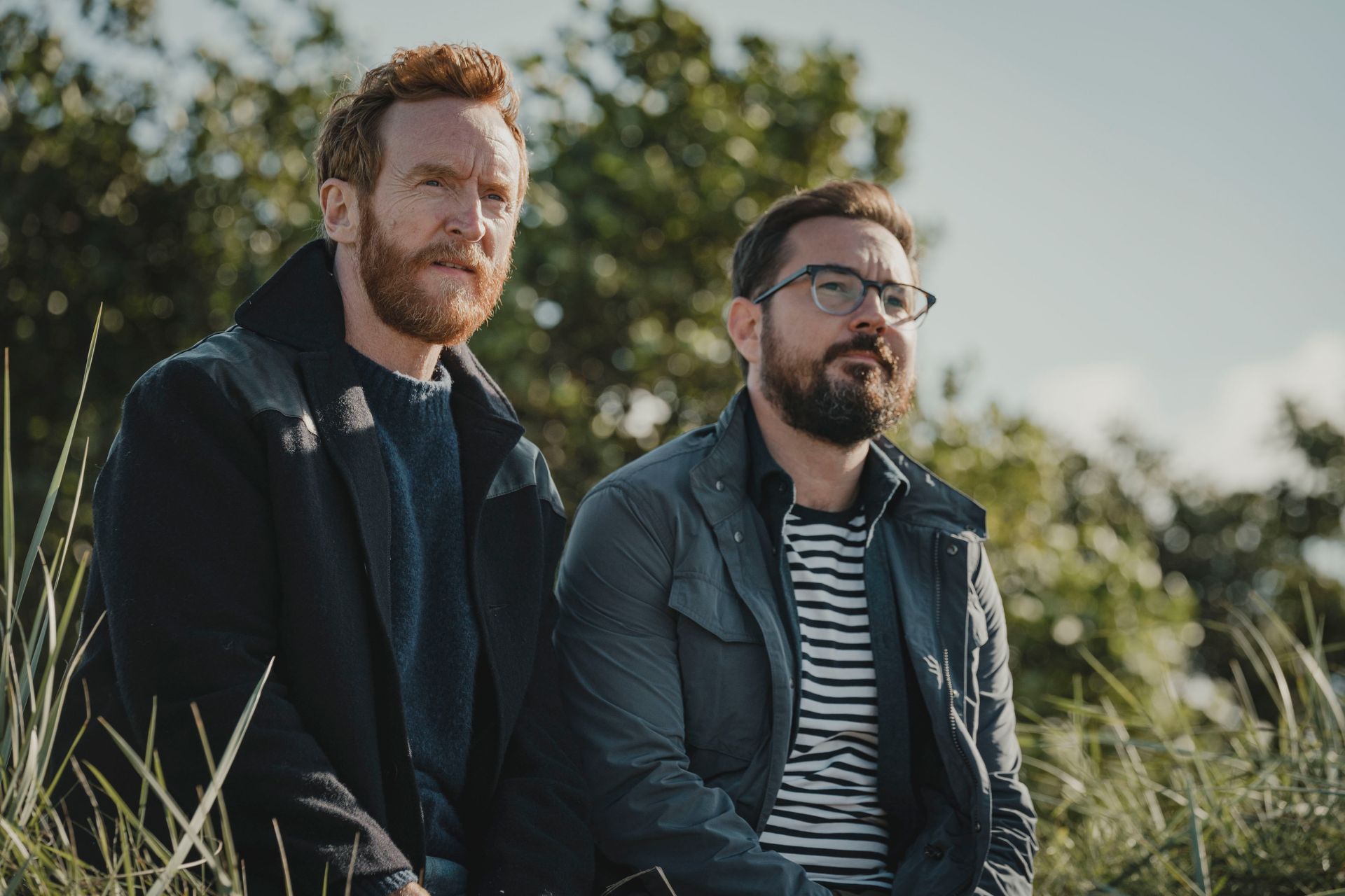 Martin Compston and Tony Curran sitting in the grass in Mayflies