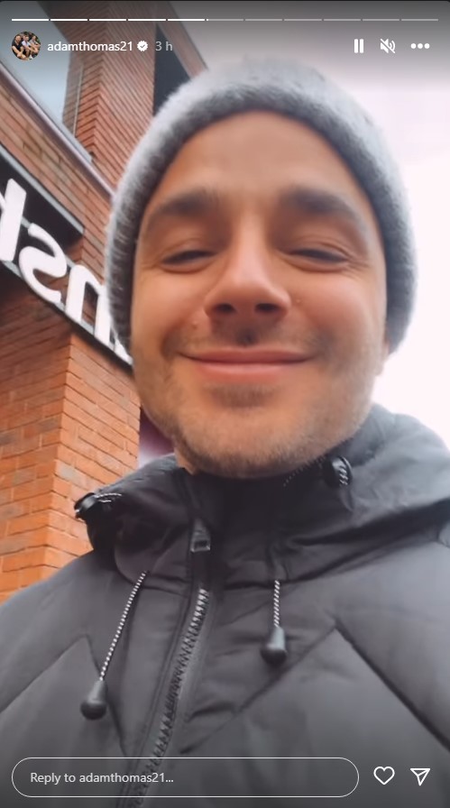 Emmerdale's Adam Thomas is smiling to the camera on Instagram