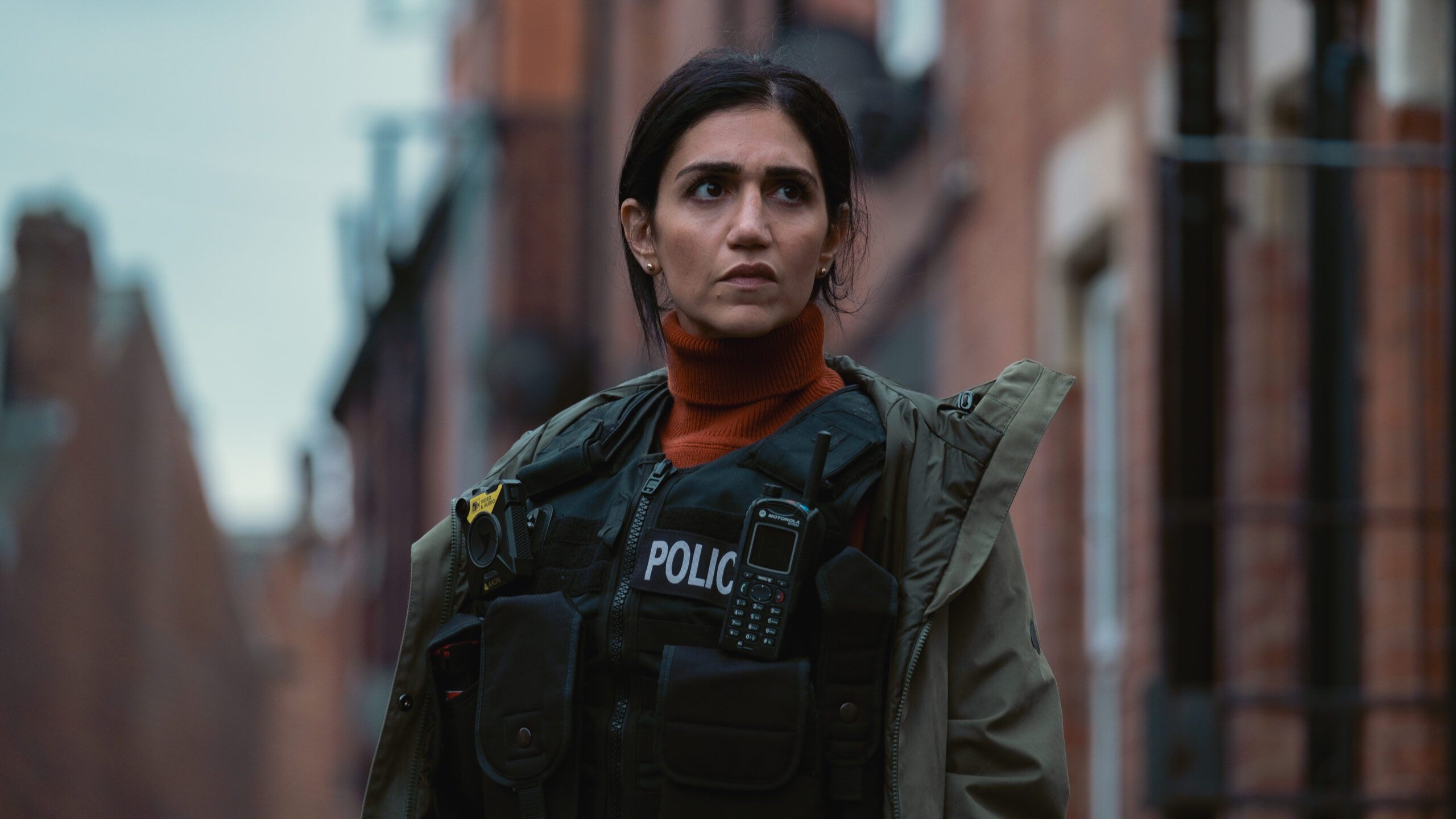 Lou stands in her police uniform in Better episodes