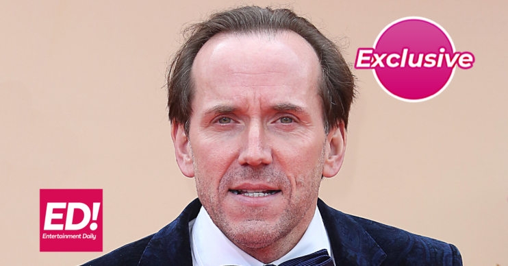 Death In Paradise star Ben Miller against a beige board
