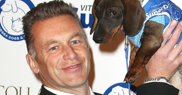 Chris Packham holding a dog