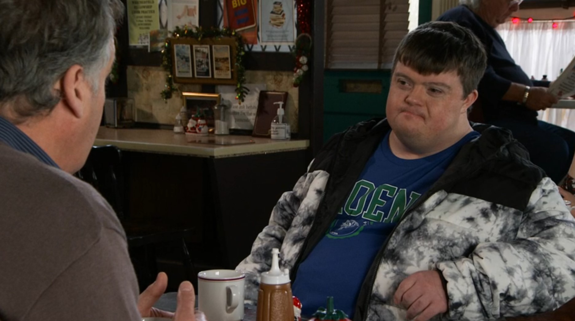 Coronation Street's Alex sits and talks to Brian in the cafe