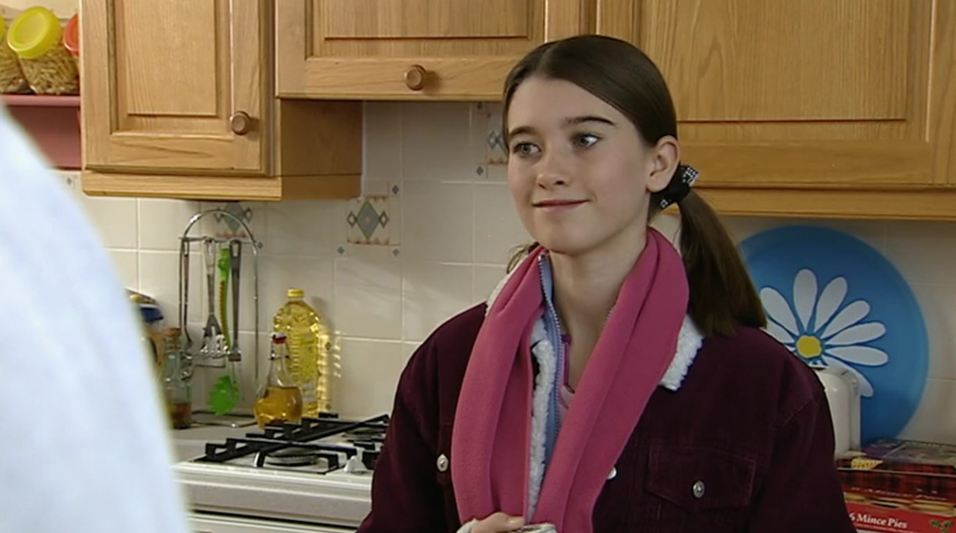 Debbie Dingle forces a smile as she talks to Paddy and Emily in the kitchen