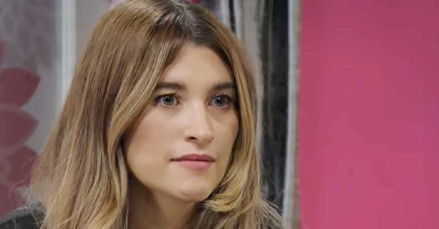 Charley Webb, smiling as Debbie Dingle in Emmerdale looks serious