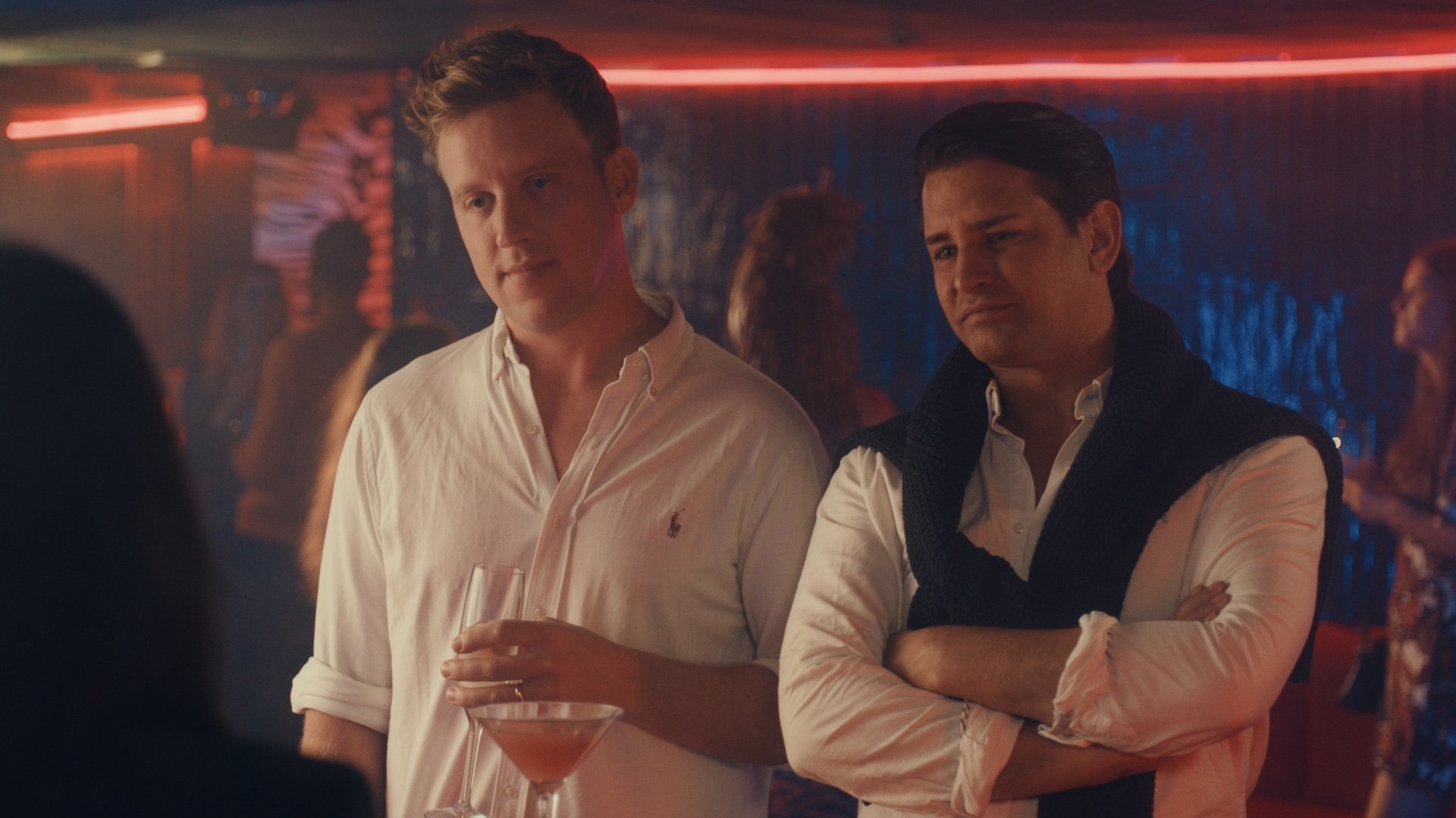 Gareth Locke holding a drink and Ollie folding his arms in Made In Chelsea