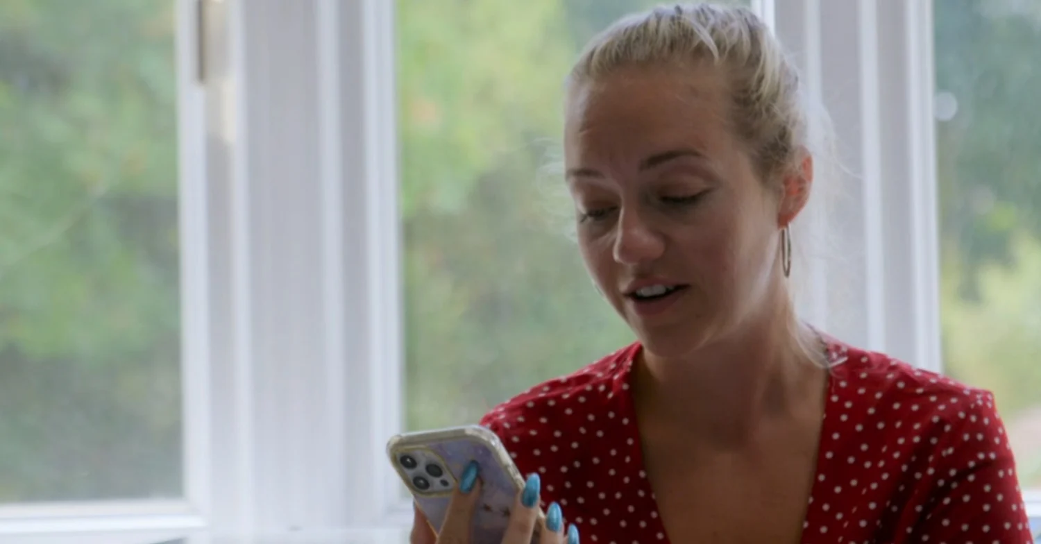 Kelsey Parker reading a text message off her phone