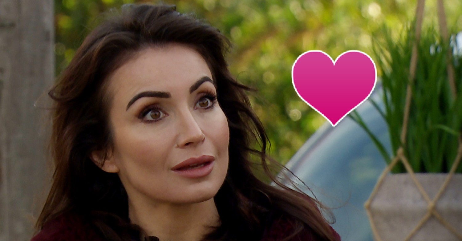 Leyla looking shocked with a pink heart in Emmerdale