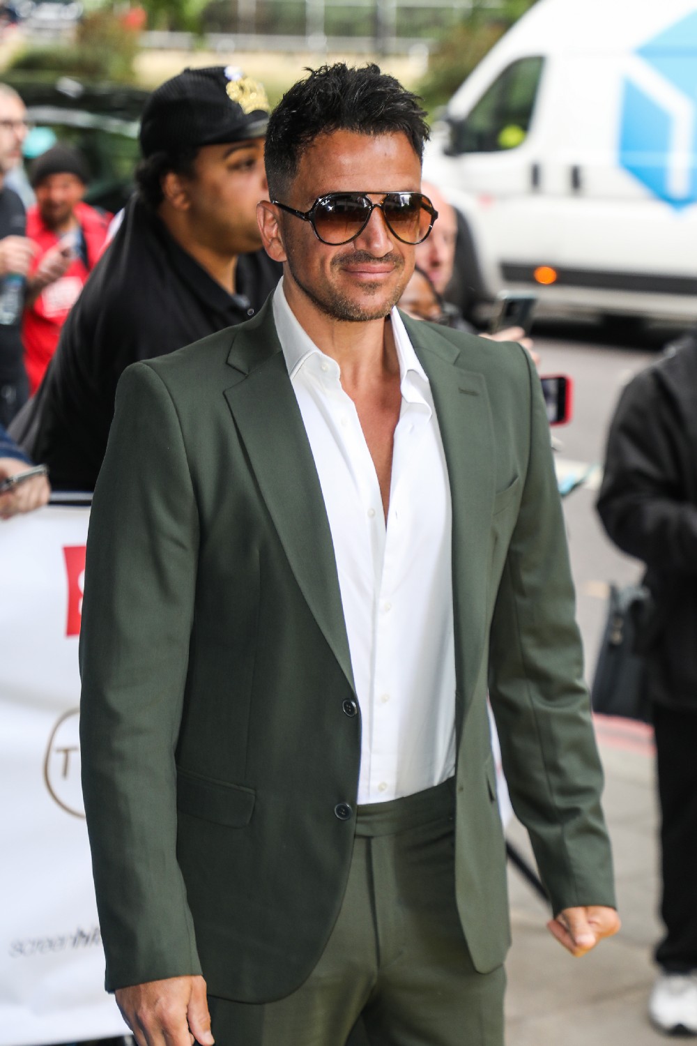 Peter Andre smiling in sunglasses at TRIC Awards