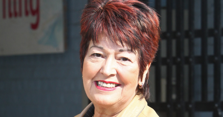 Ruth Madoc smiling in a leather coat