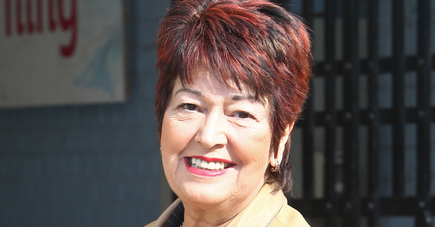 Ruth Madoc smiling in a leather coat