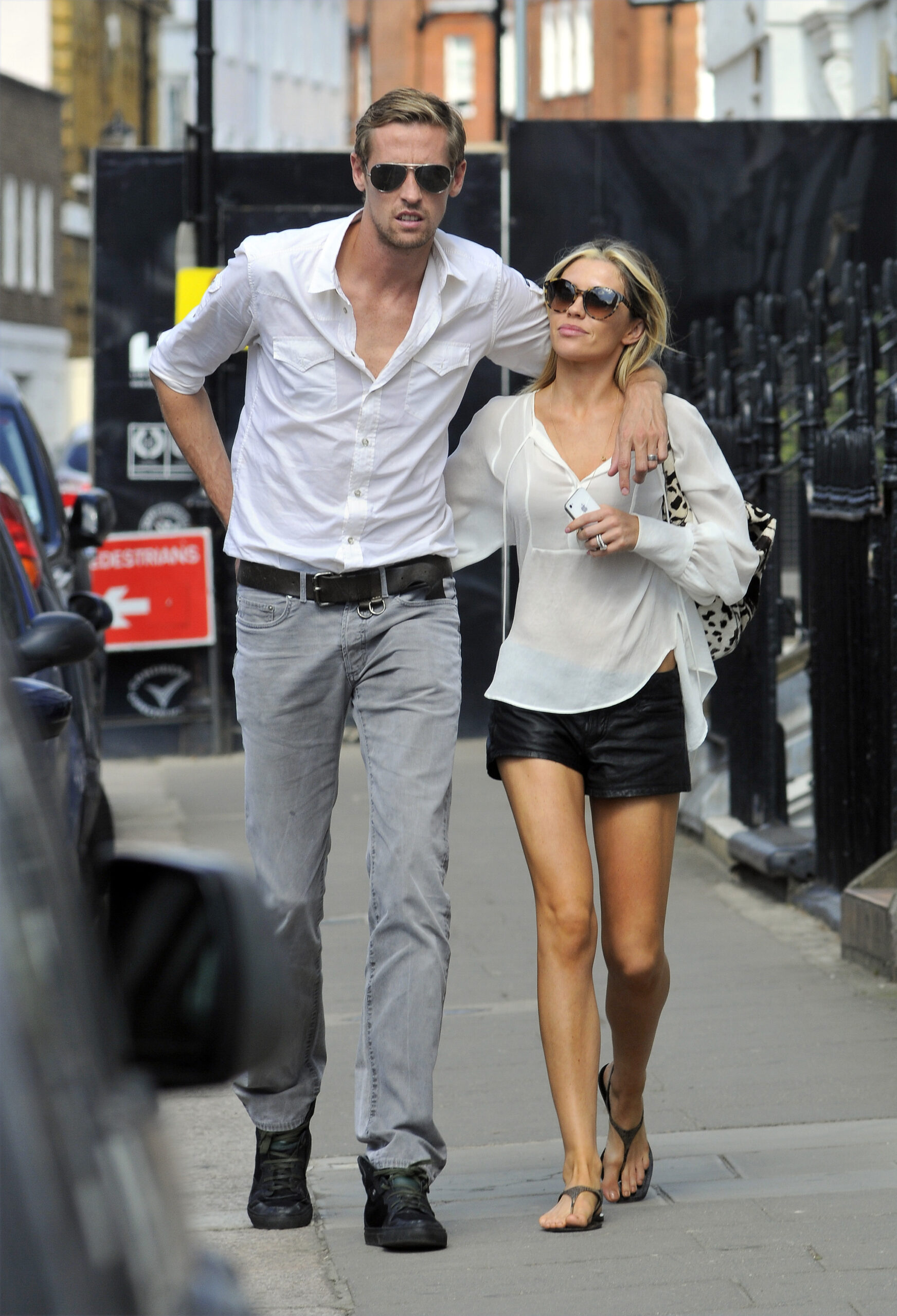 Peter Crouch walks with his arm around Abbey Clancy