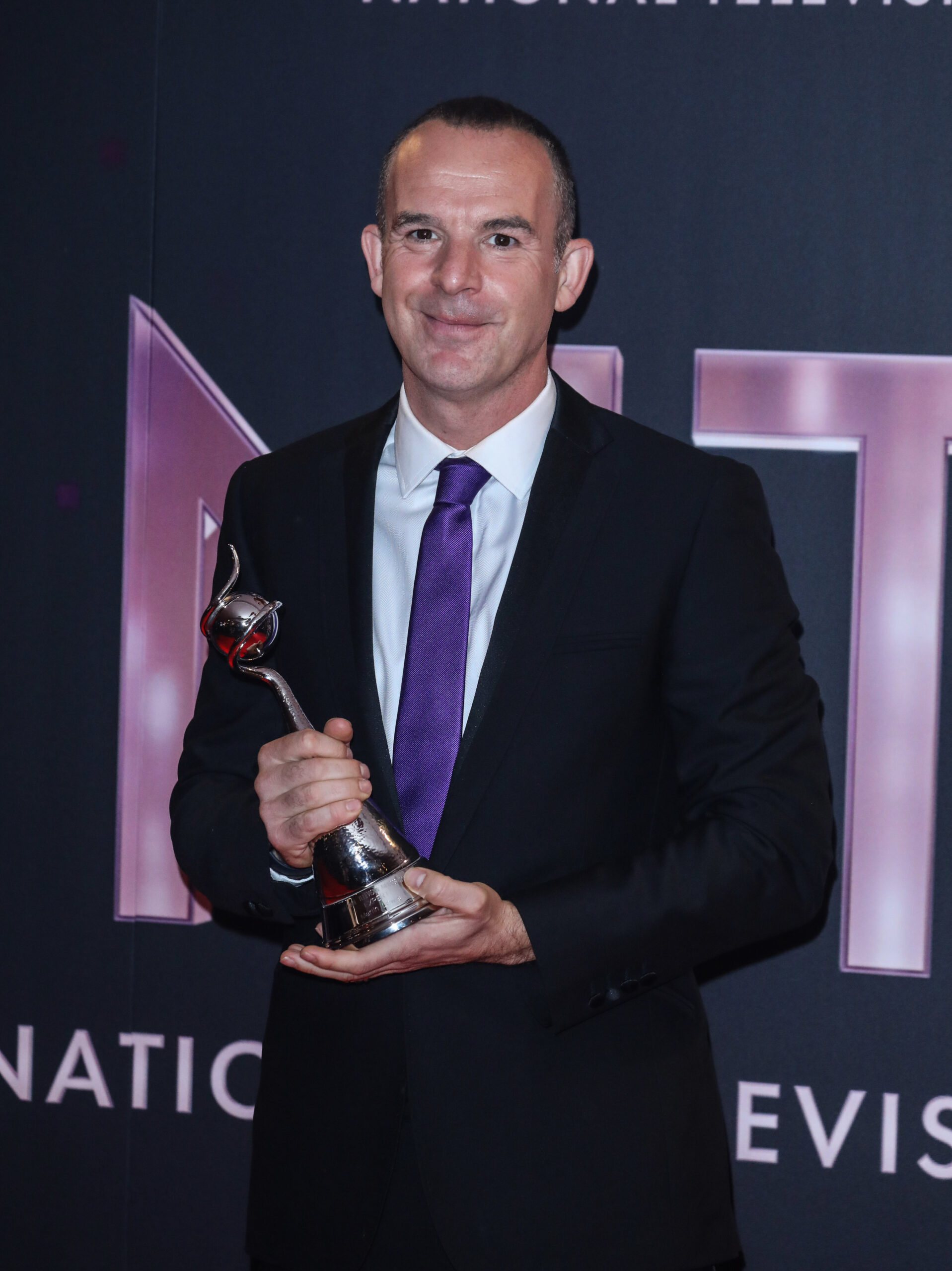 Martin Lewis holding his NTA award